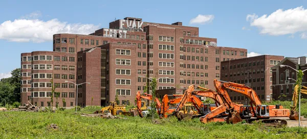 Demolition equipment lined up in front of the Cheney Memorial Building